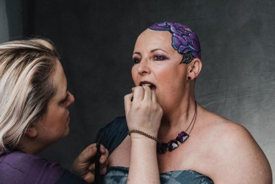 Model having lipstick applied for a photoshoot