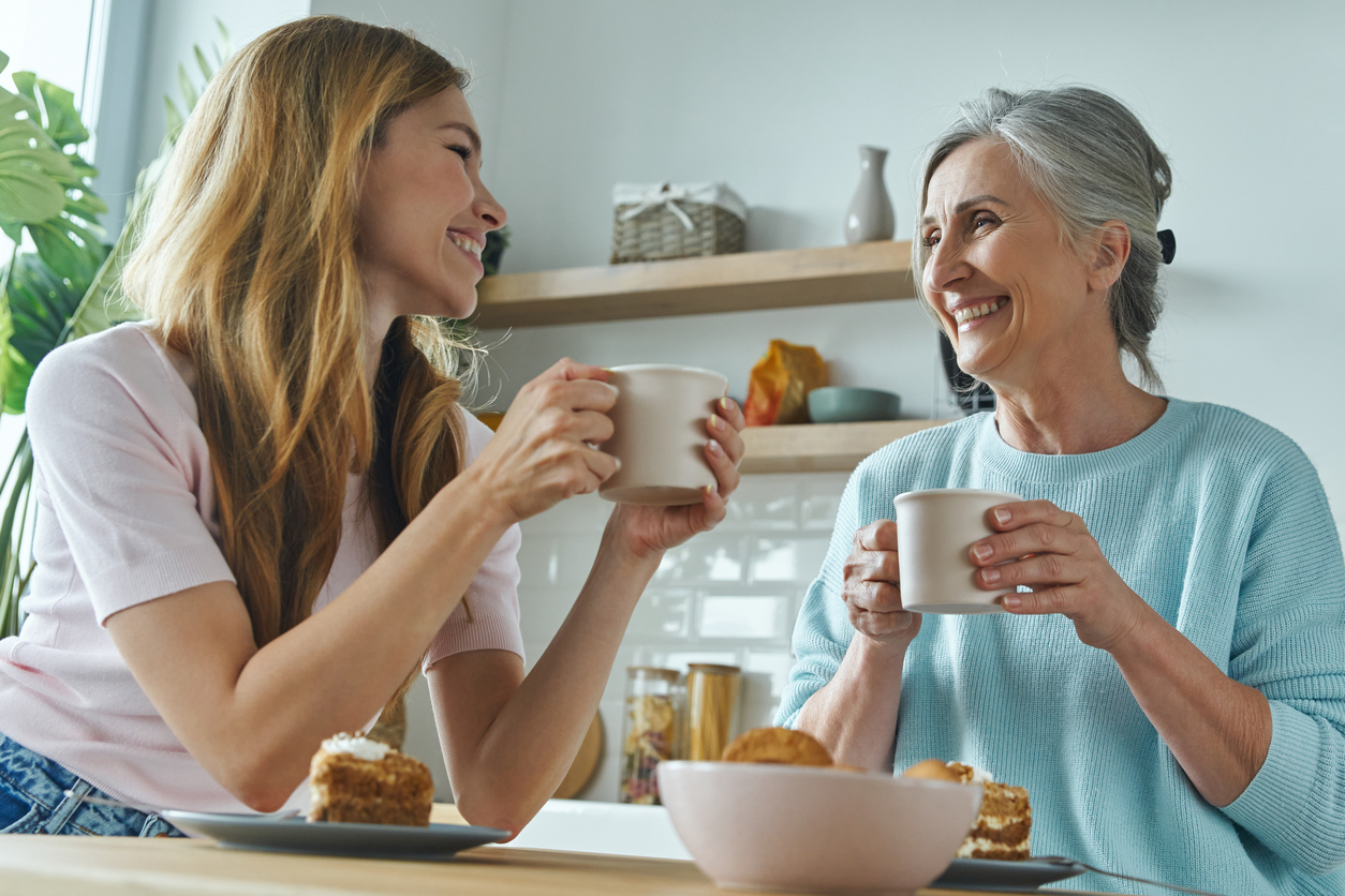 Older woman and younger woman enjoying a cup of tea