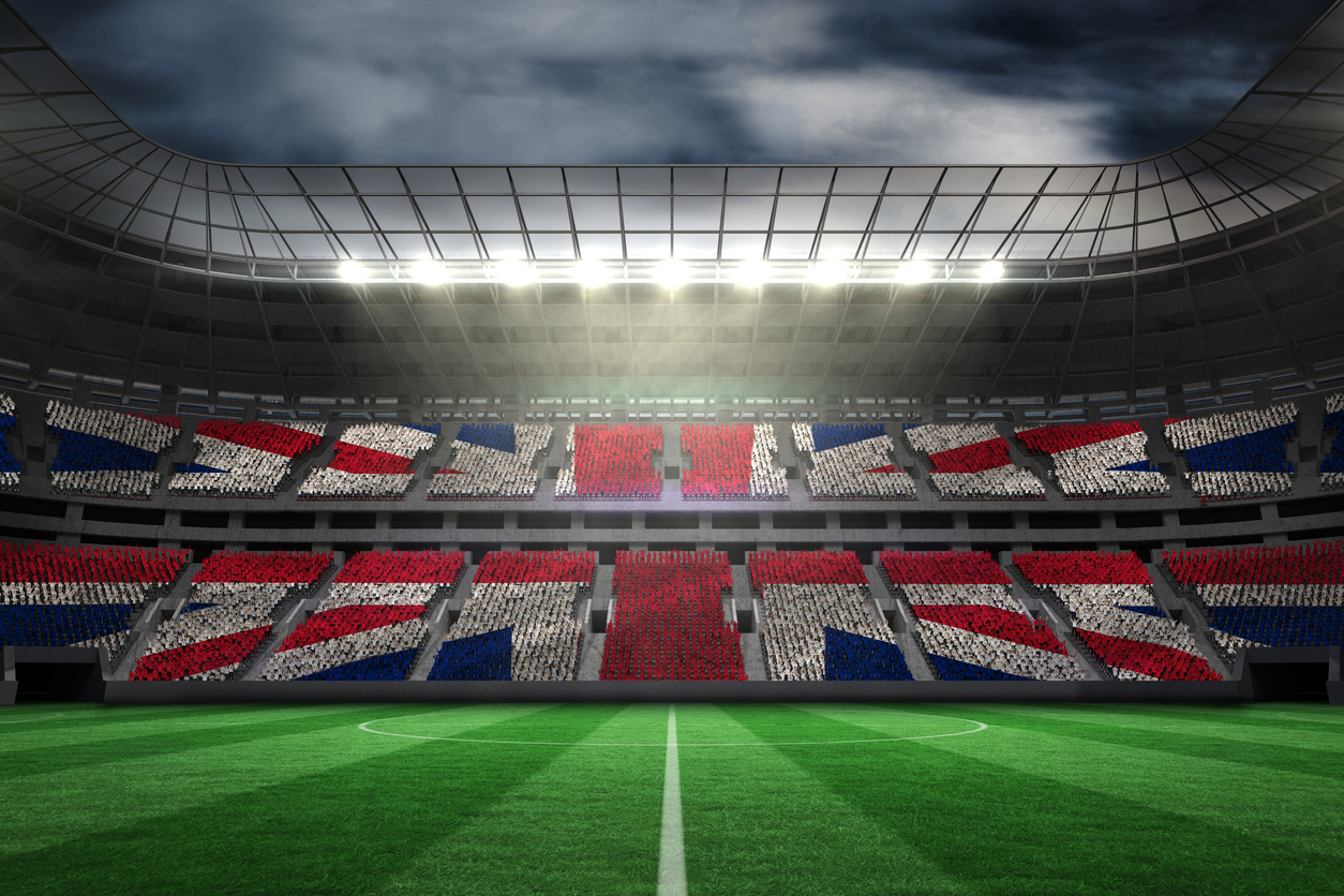 Digitally generated uk national flag against large football stadium