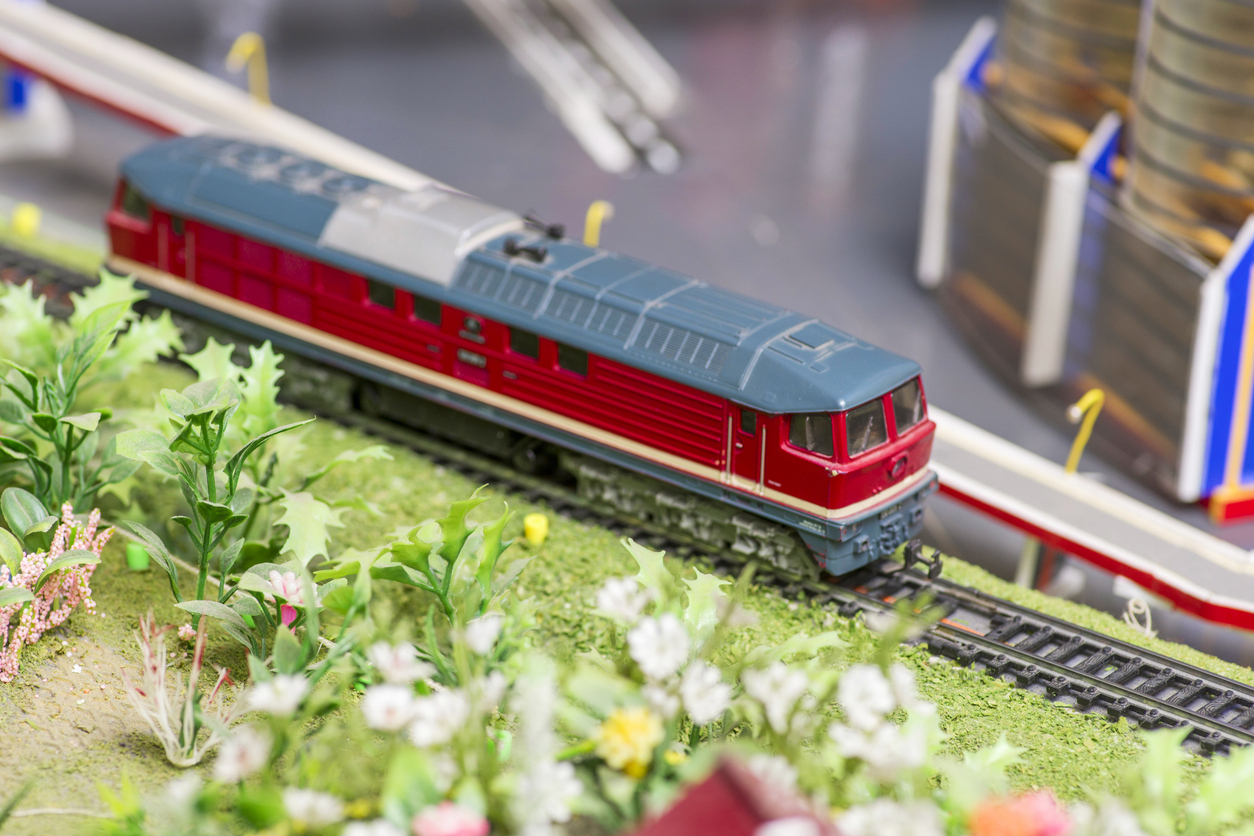 Railway modelling. Close-up about model train on the rail tracks.