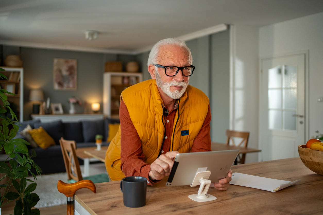 Elderly man using iPad