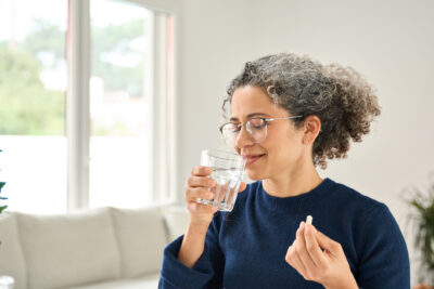 Woman taking macaroni supplement