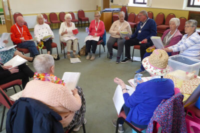 The group sing along – some with basic musical instruments to add to the fun and with Martyn at the piano