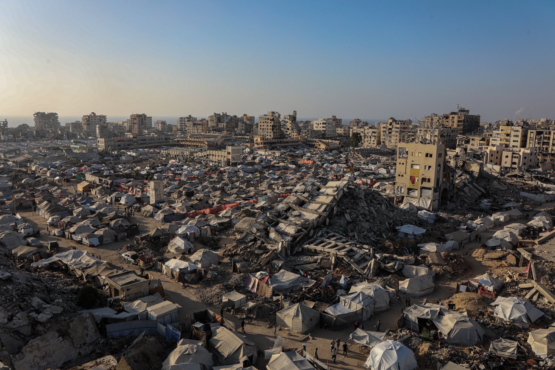 Tents sheltering internally displaced Palestinians are seen amid war-damaged infrastructure in Gaza City, on June 15, 2025. Credit: Omar Ashtawy/apaimages/IPPG/Photo North Festiva