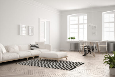 Bright minimalist living room with sofa and dining table, scandinavian white interior design