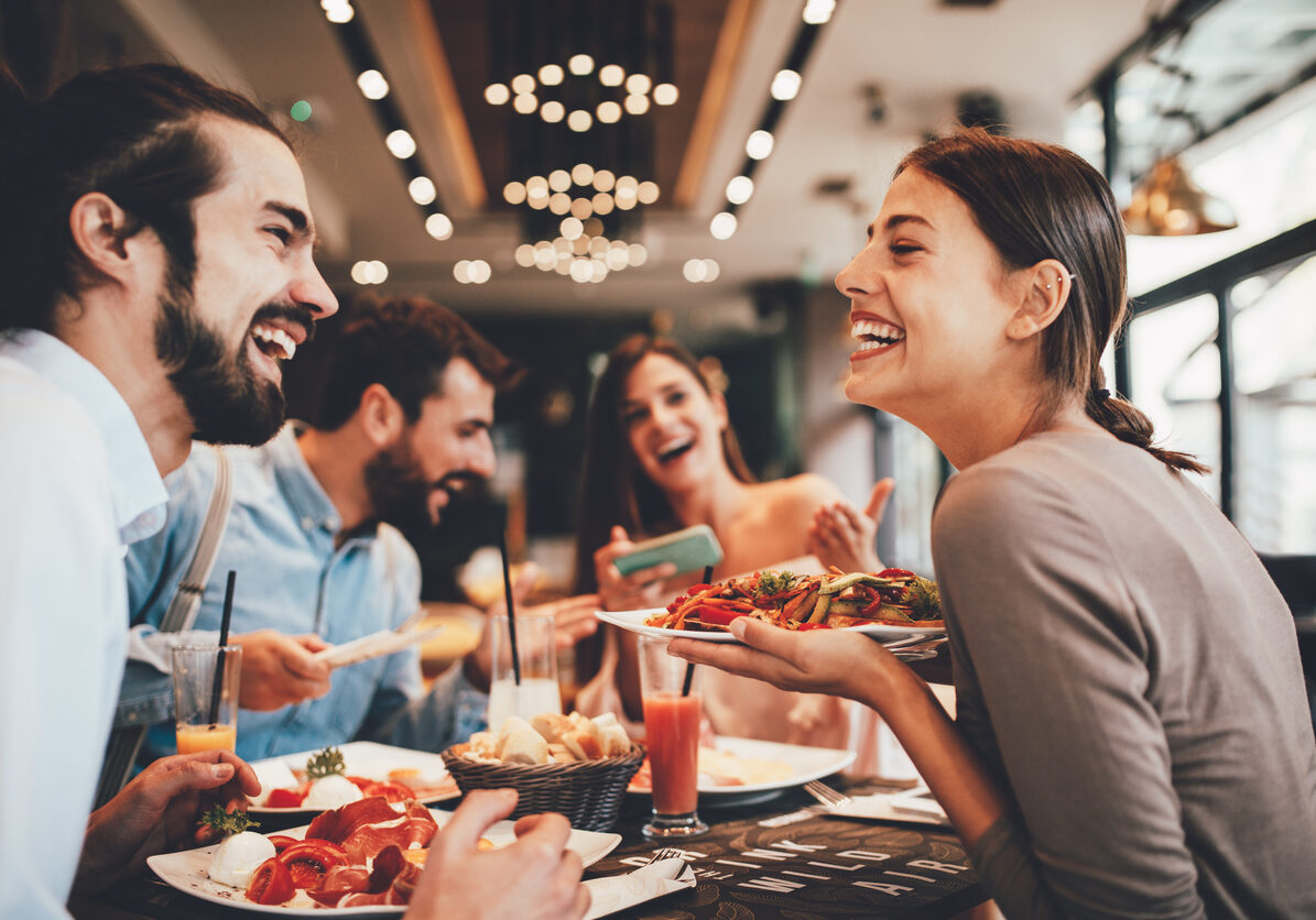 Group of Happy friends having breakfast in the restaurant