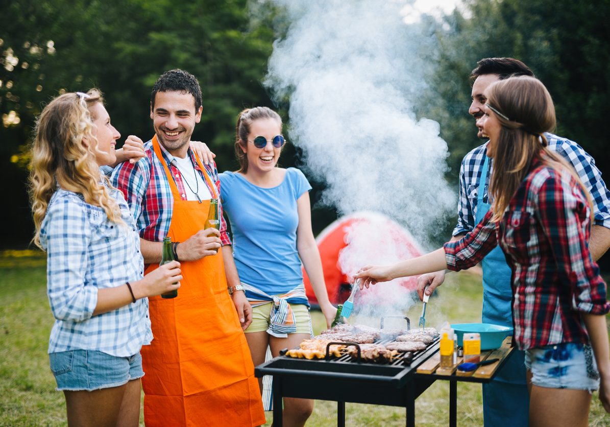 Young people in nature having a bbq party