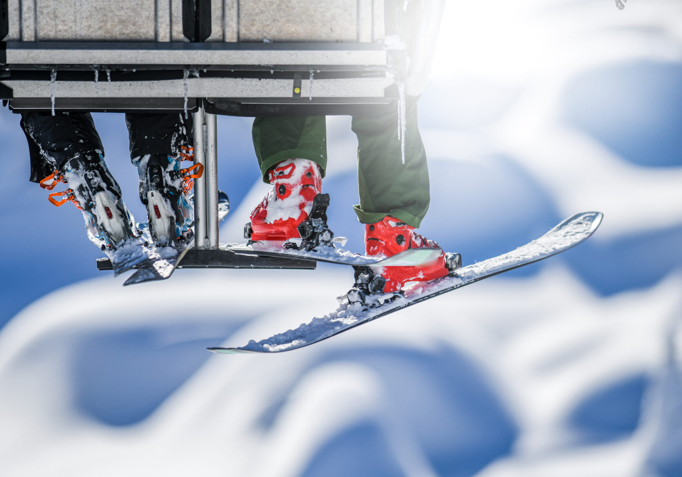 People lifting on ski-lift in winter sunny the mountains detail.