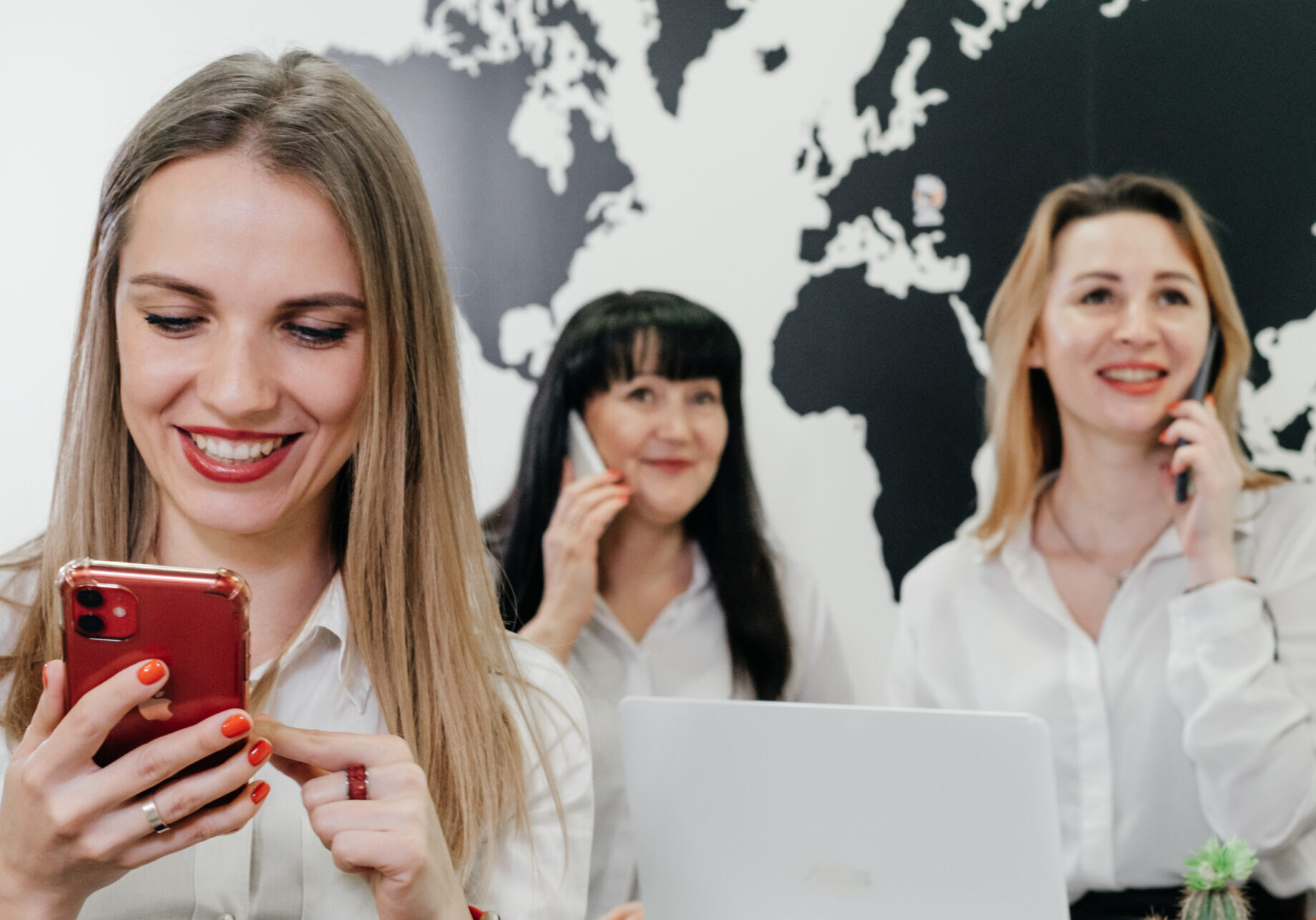 Travel agency working on-line in office, communicating with clients via phone and Internet over the world map. Manager gives information online, consulting tourists