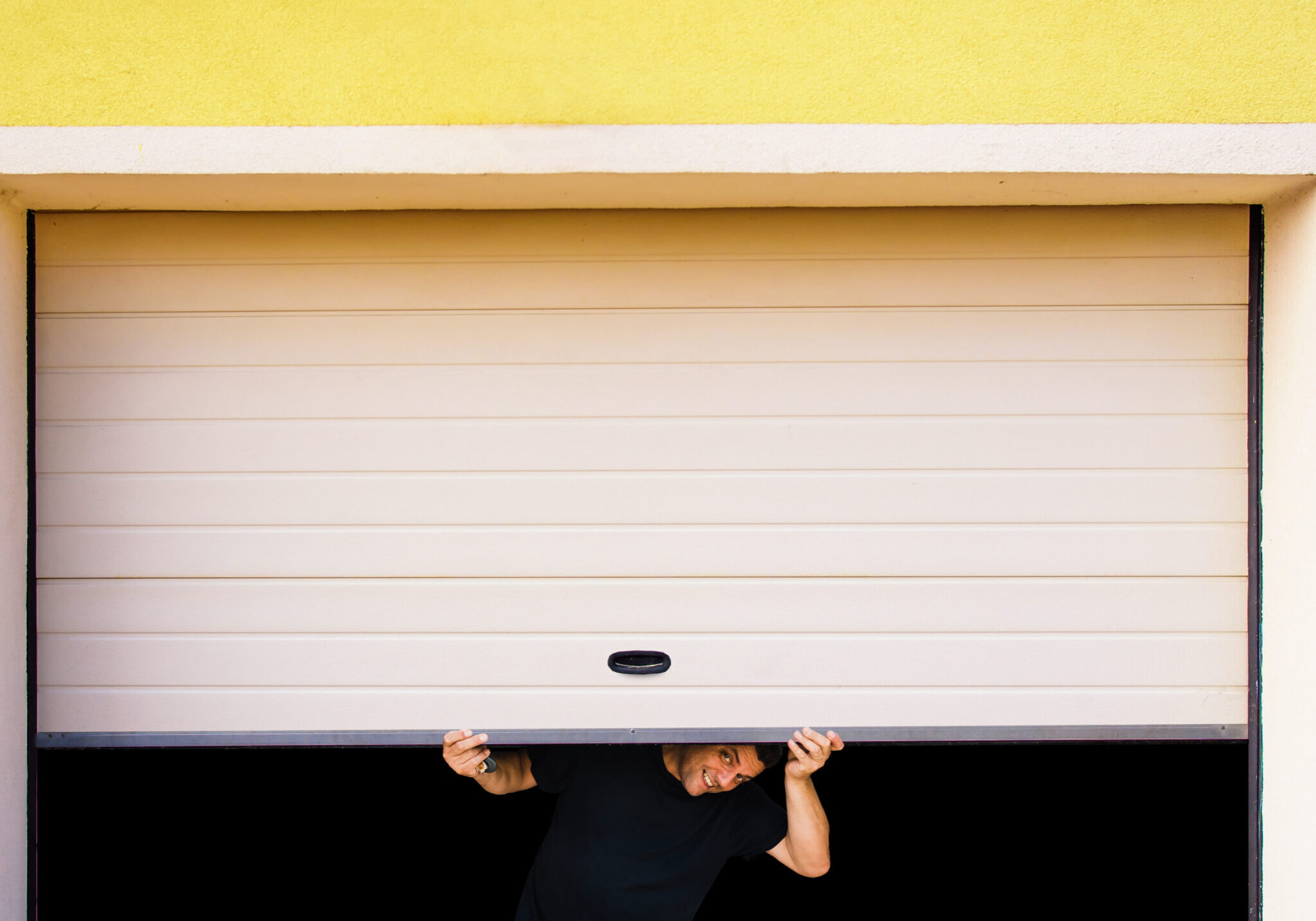 man with hands holds pvc garage door