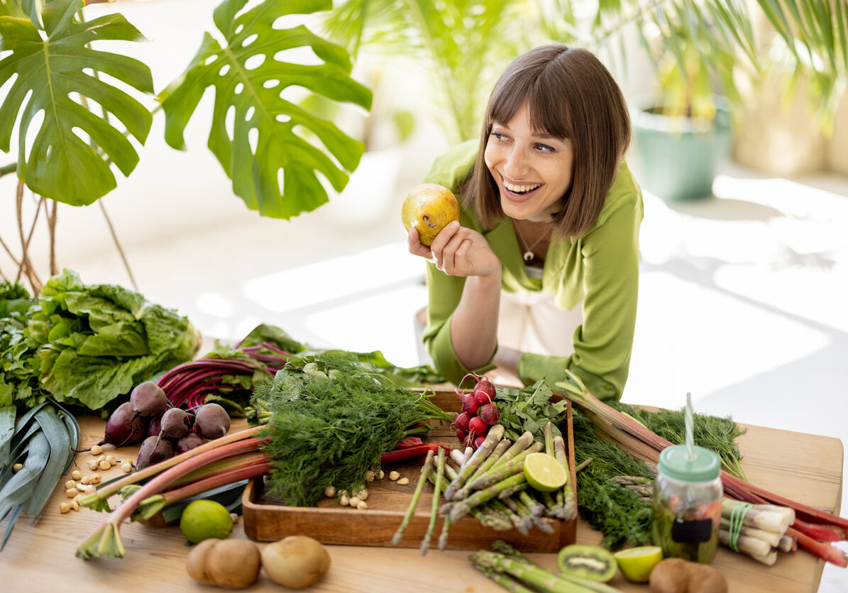 Woman with fresh healthy food ingredients indoors