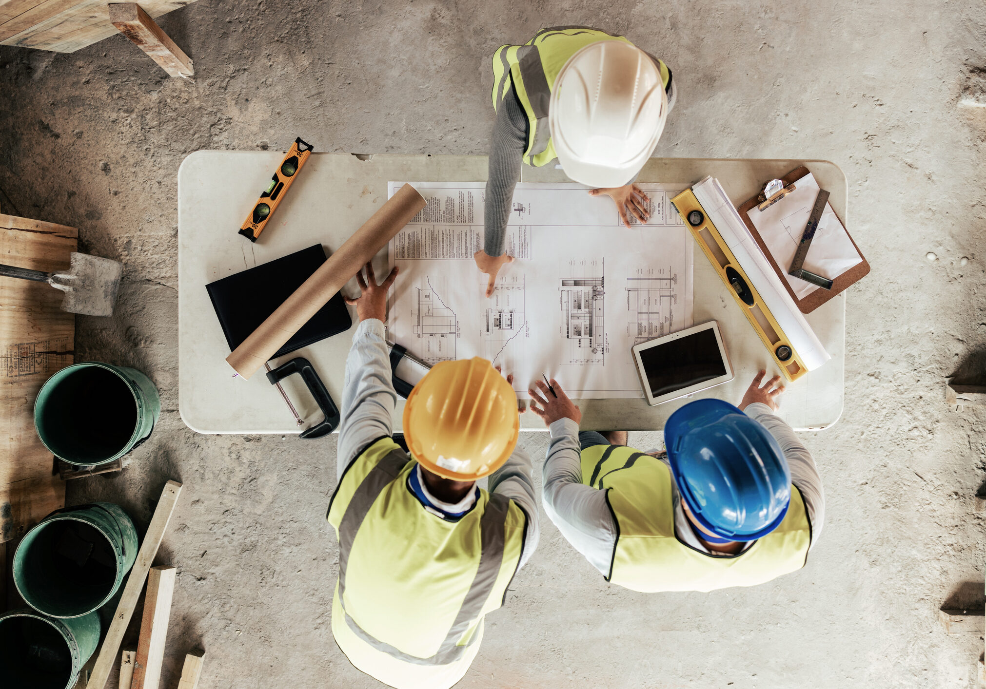 Top view, construction workers or blueprint planning in house, home or office building in real estate, property or architecture innovation. Men, engineering woman or construction site people or ideas