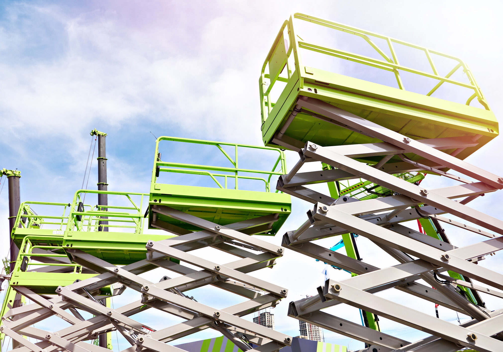 Construction scissor lifts on sky