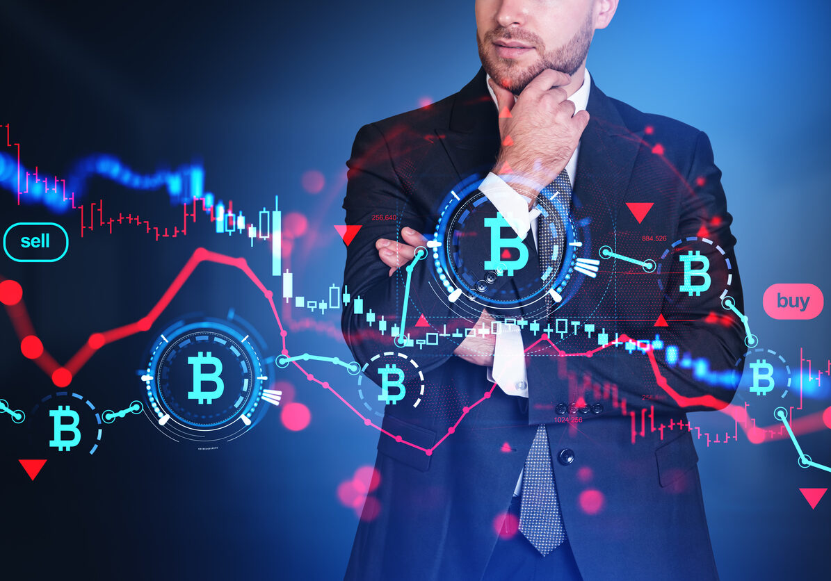 Businessman standing with thoughtful look, virtual screen with bitcoin chart, red candlesticks and glowing lines hud. Concept of cryptocurrency and trading.