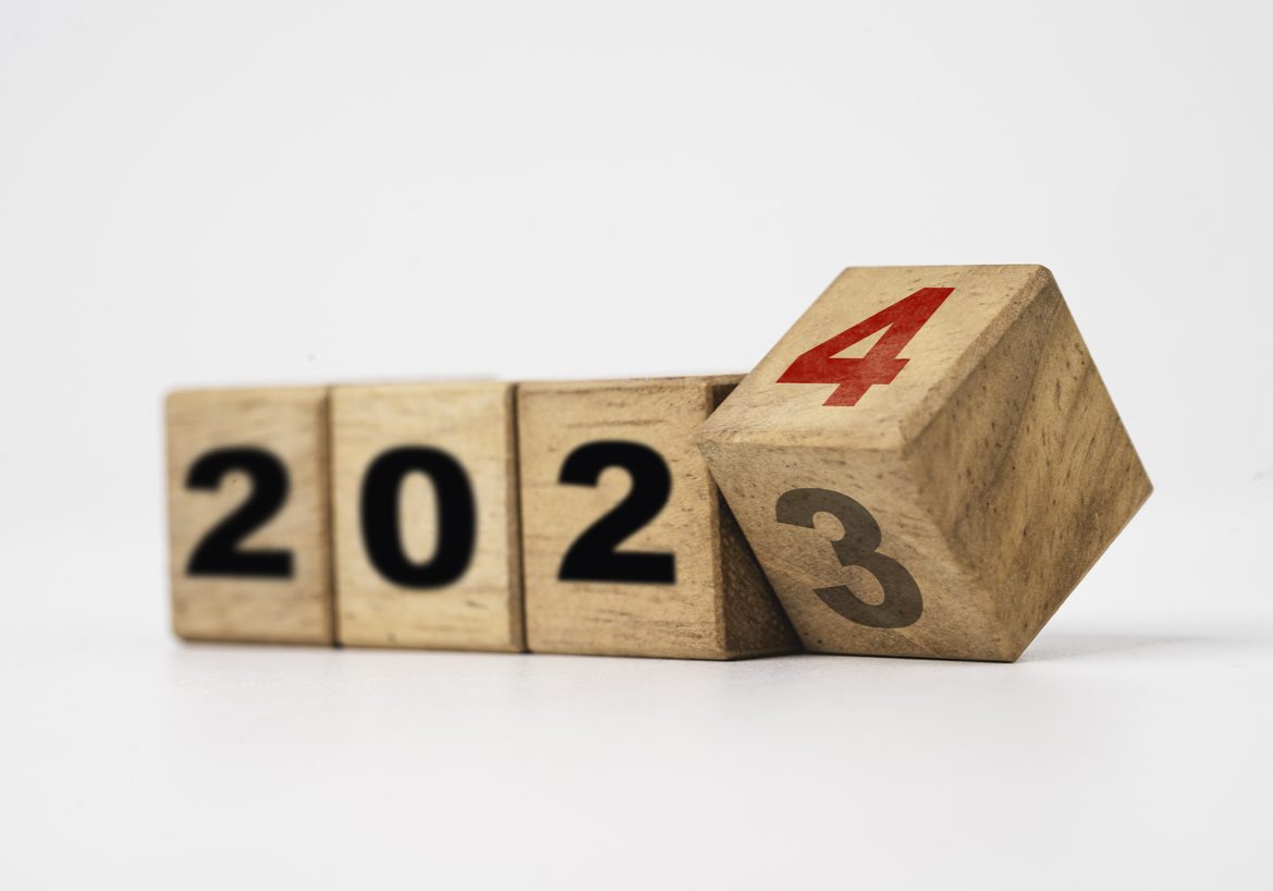 Flipping of 2023 to 2024 on wooden block cube for preparation merry Christmas and happy new year change and start new business target strategy concept.