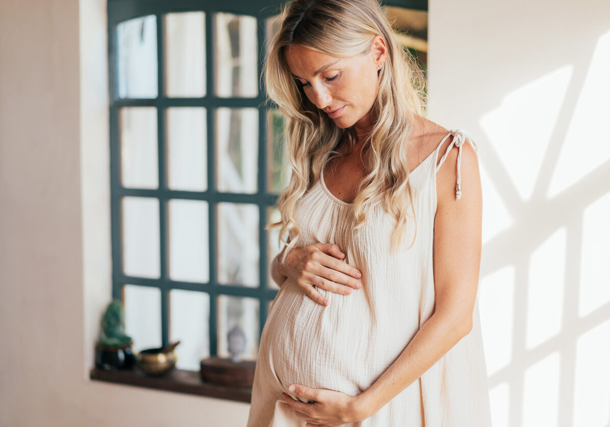 Pregnant woman holding belly