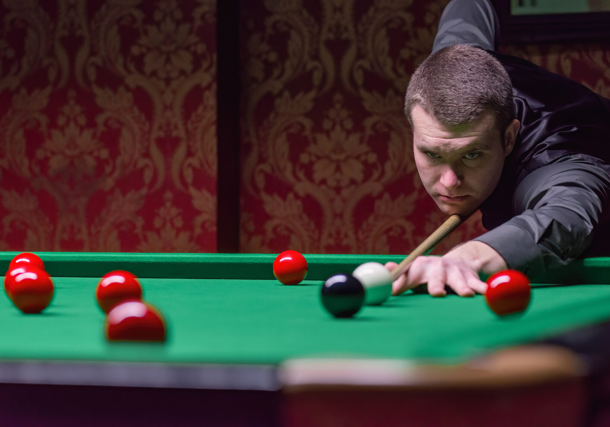 A competitive and strategic snooker game in progress, showcasing cue sports skill, precision, and sportsmanship