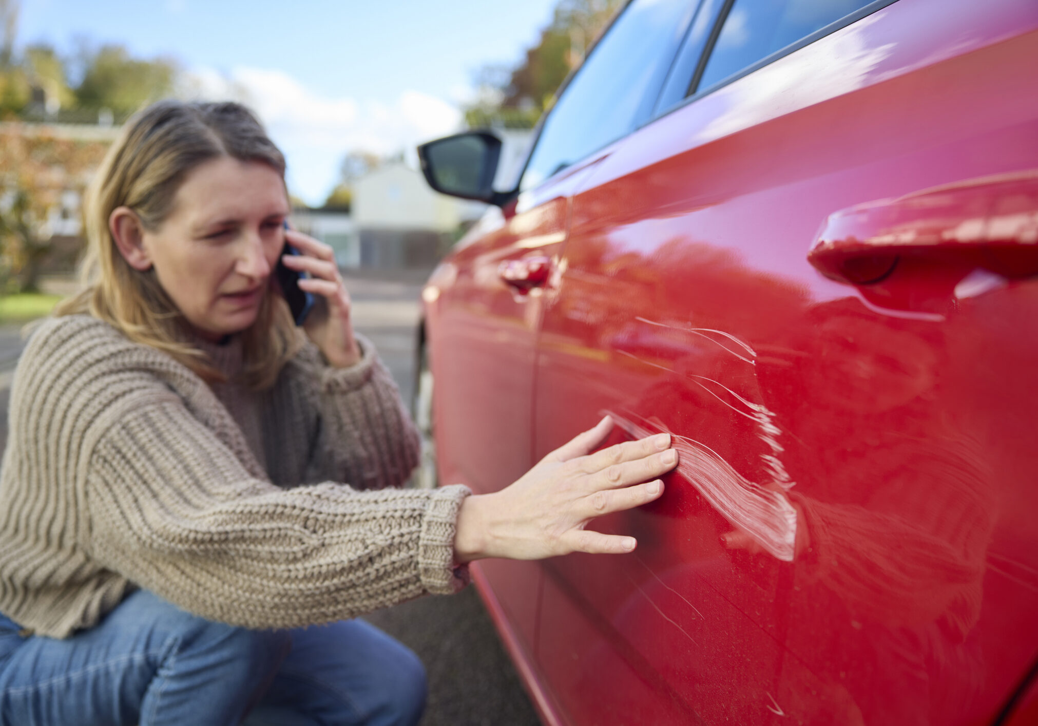Unhappy Mature Female Driver With Damaged Car After Accident Calling Insurance Company On Mobile Phone