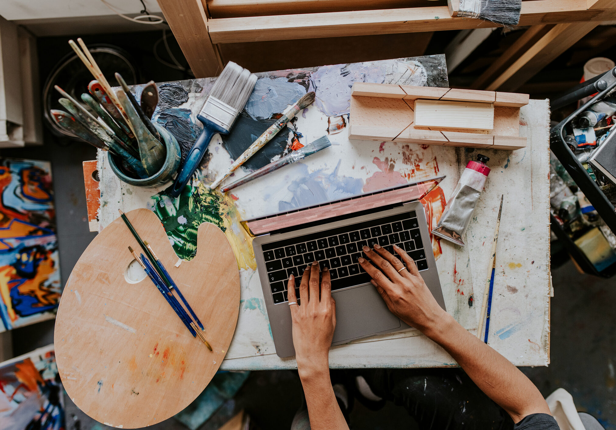 Artist working on her laptop in her studio