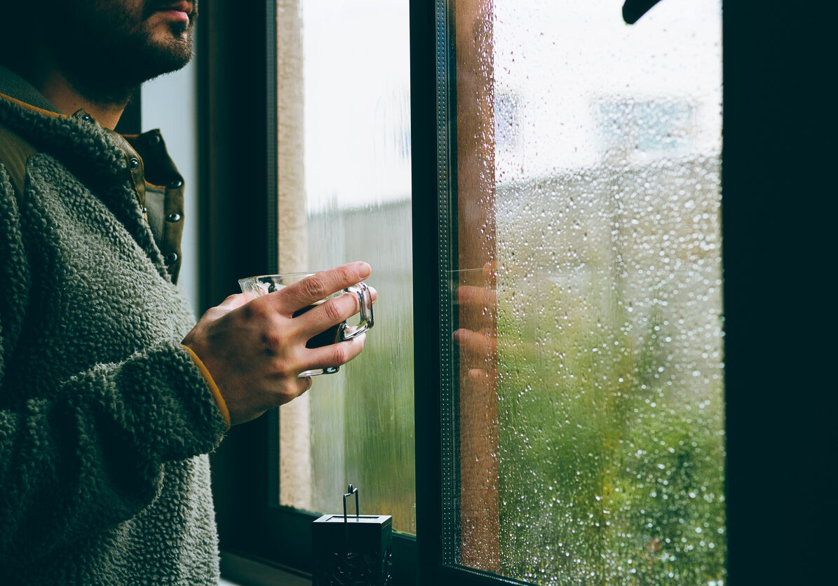 Man Drinking Coffee At Window