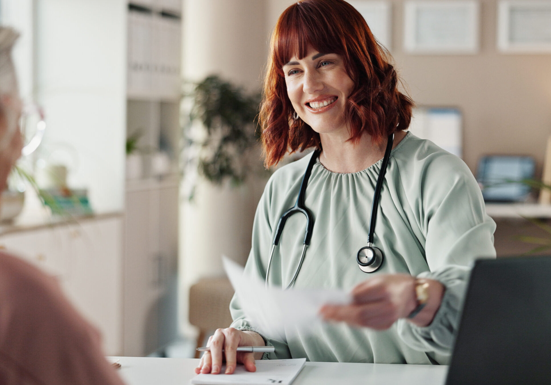 Hospital, paperwork and doctor with senior patient for consulting, medical service and medicine prescription. Healthcare, clinic and woman with person for insurance forms, diagnosis and results