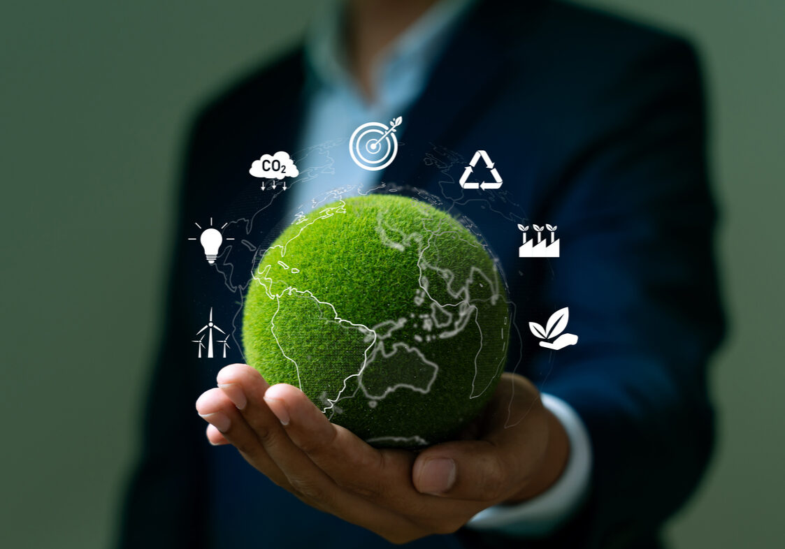 World environment day, Responsibility for a green planet, Sustainable growth, and global conservation.Businessman holding green world, Sustainable development goals and corporate social responsibility