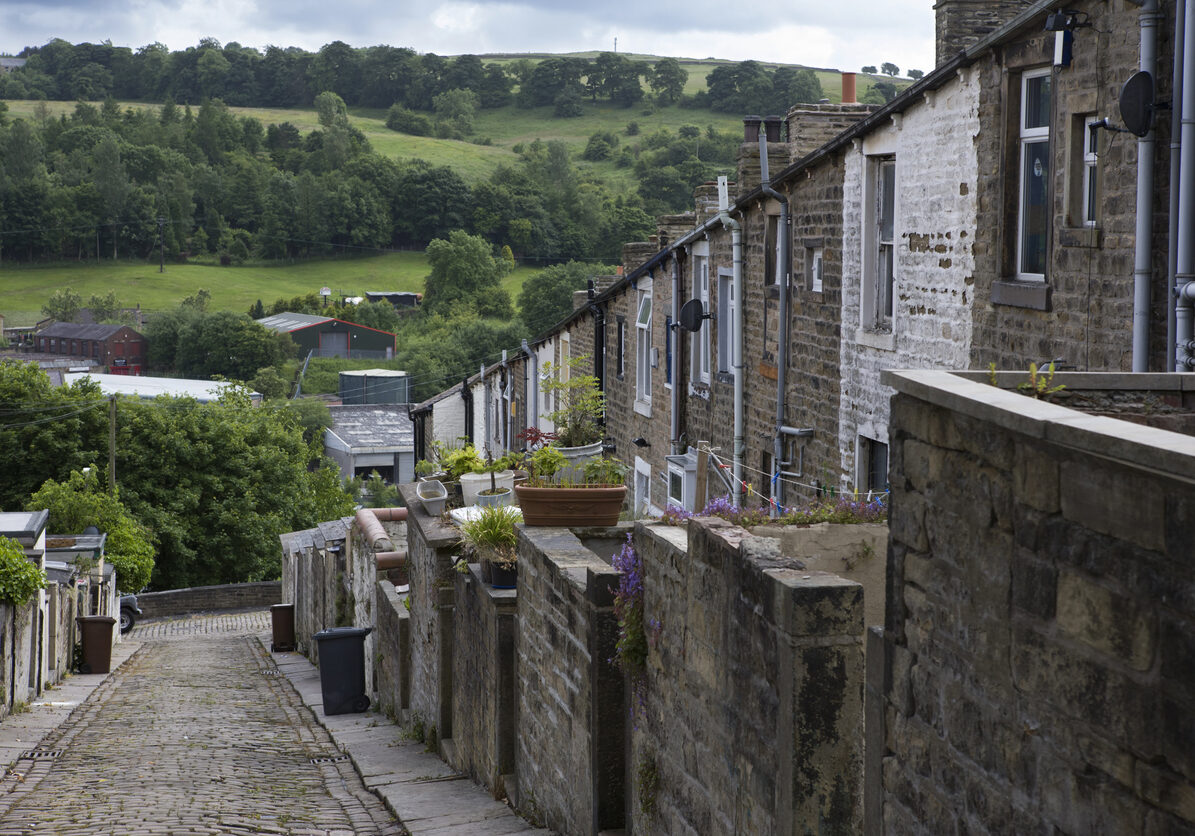 A steep terrace of traditional 19th century millworkers' cottages in Colne, Lancashire.  With the Industrial Revolution, cotton manufacturing became the main industry in the town and by 1891 there were 30 cotton mills listed in Colne. This late 19th century terrace housed many of the millworkers.