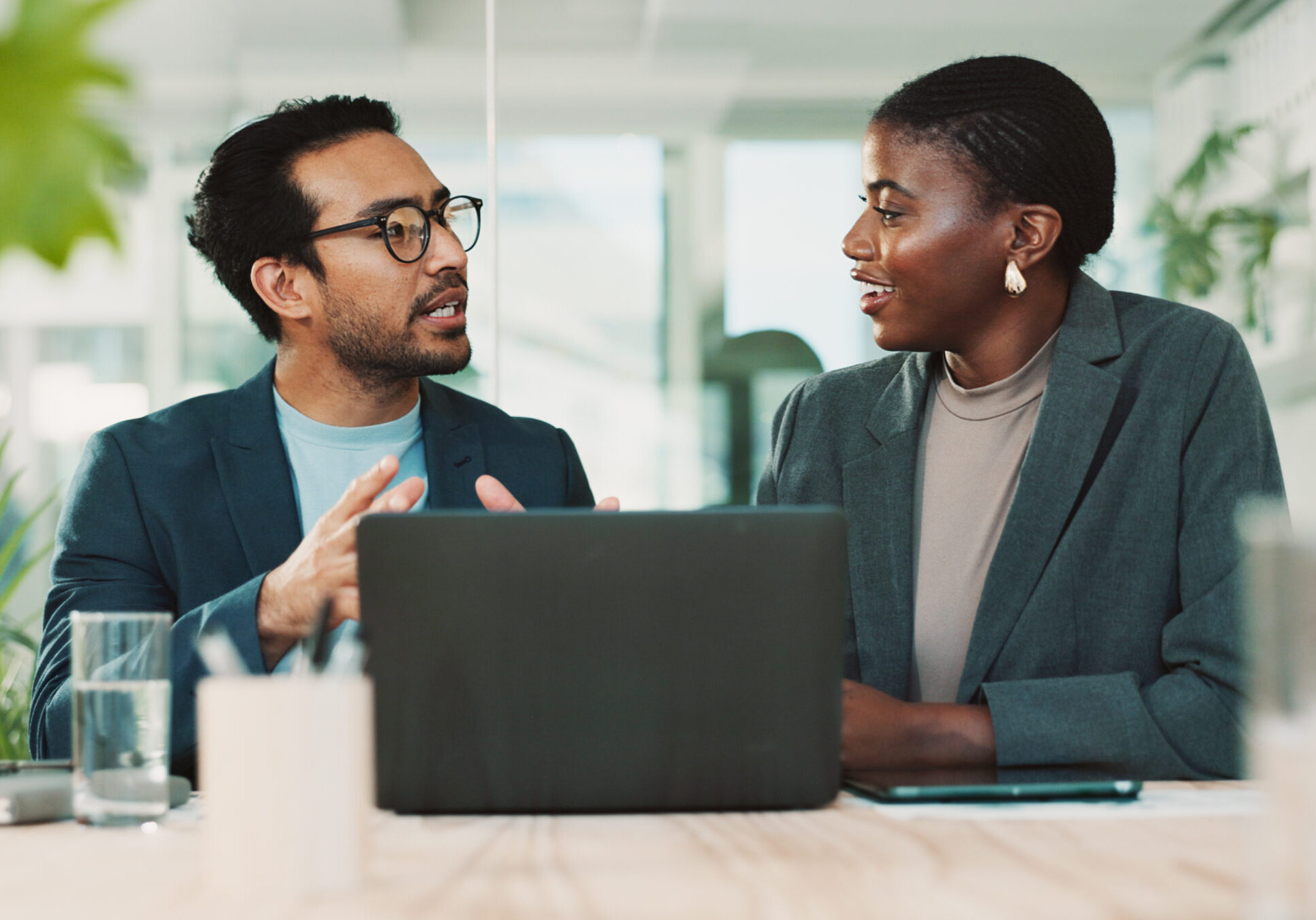 Office, partnership and team advice for laptop, proposal and research notes with document for report. Man, woman and feedback for small business, collaboration and meeting for training or b2b project