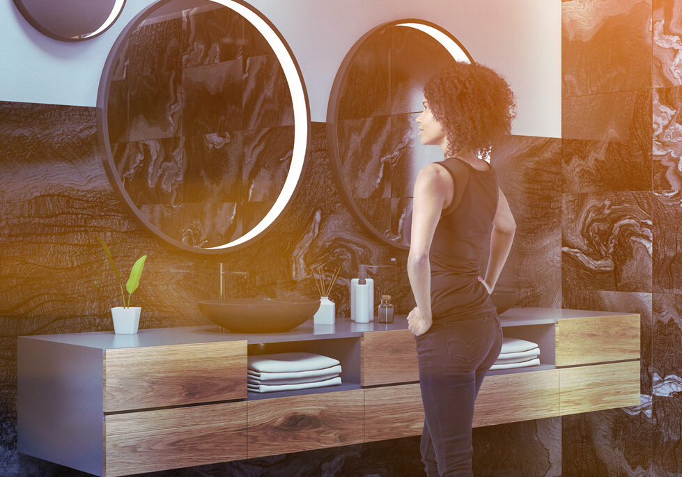 African woman in luxury black marble bathroom