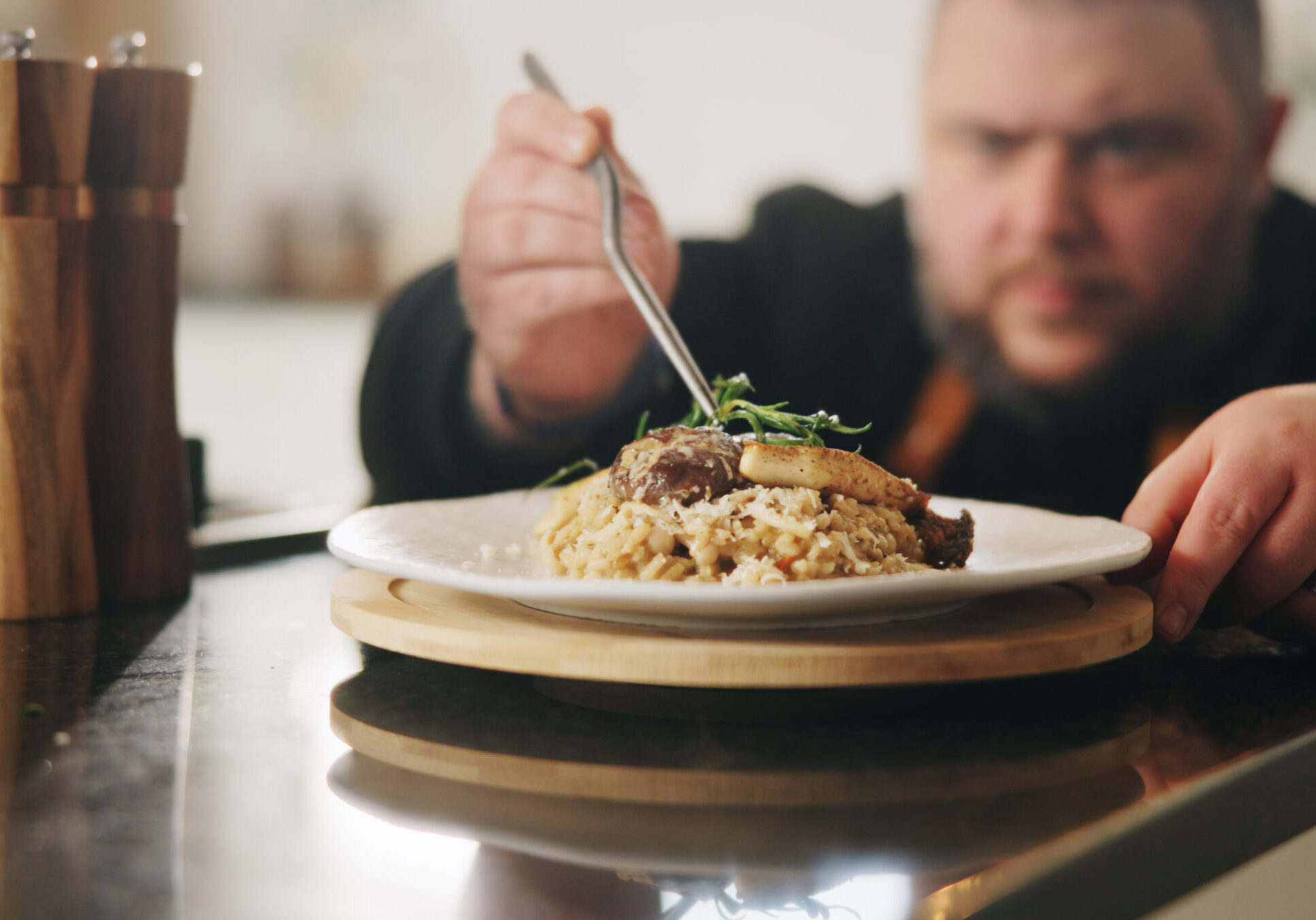 Presentation, plate or hands of man with food in kitchen of home for diet, service or nutrition. Ingredients, risotto recipe or person with dish design for gourmet cuisine, cooking mushroom or lunch