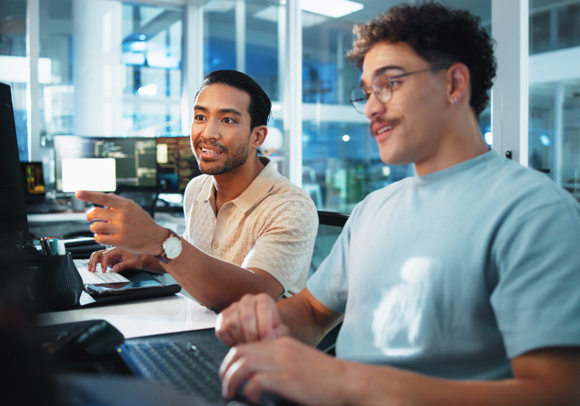 Computer, programmer and discussion with people in office for game designer, coding app and ux update. Software development, research and level gameplay with employee for developer collaboration