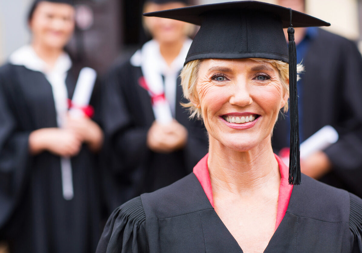 pretty middle aged university professor at students graduation ceremony