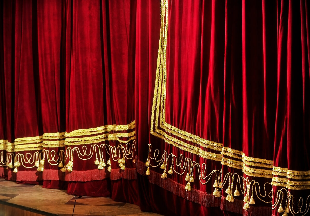 Side view with a closed opera red velvet curtain