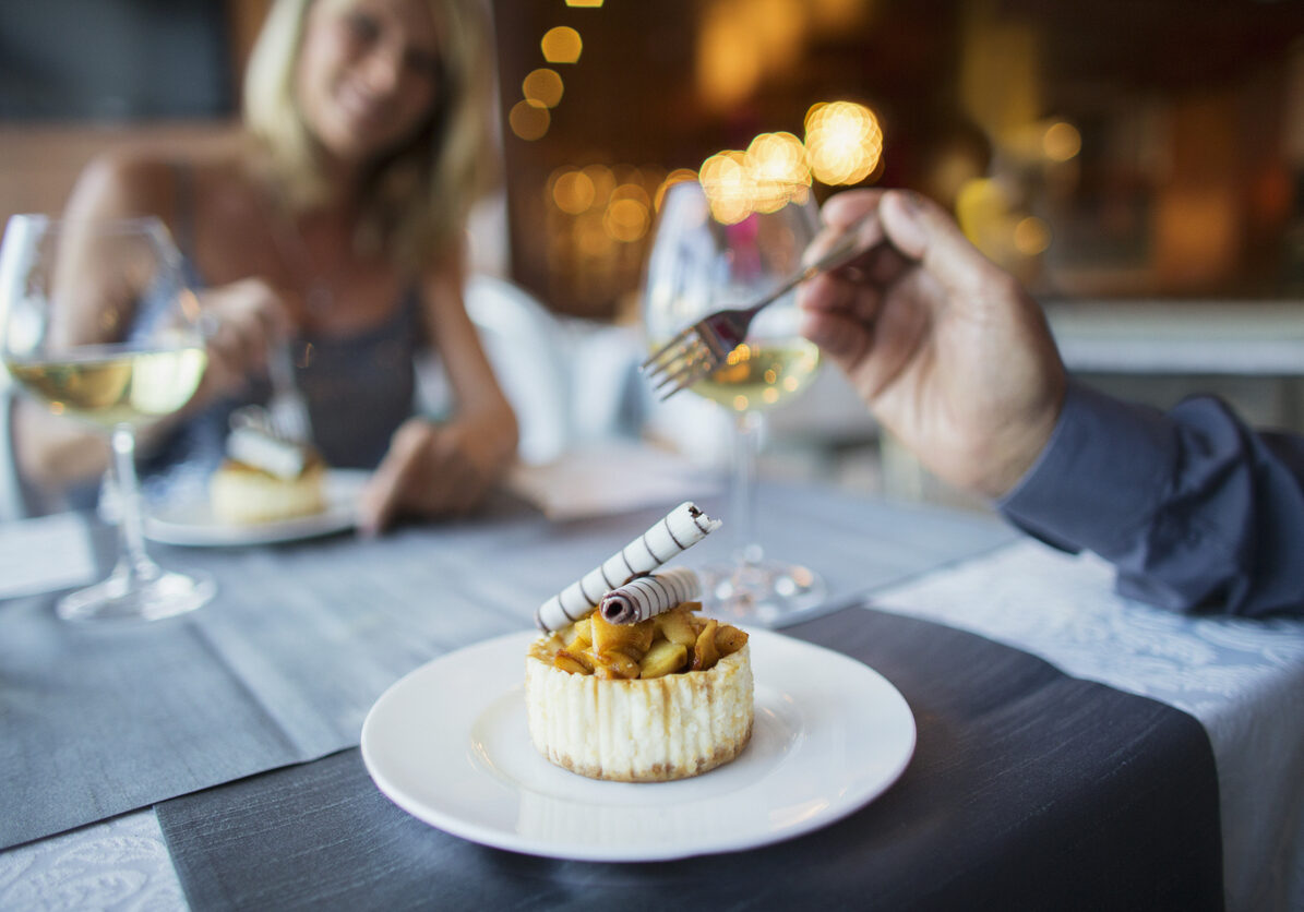 Couple eating dessert in fancy restaurant