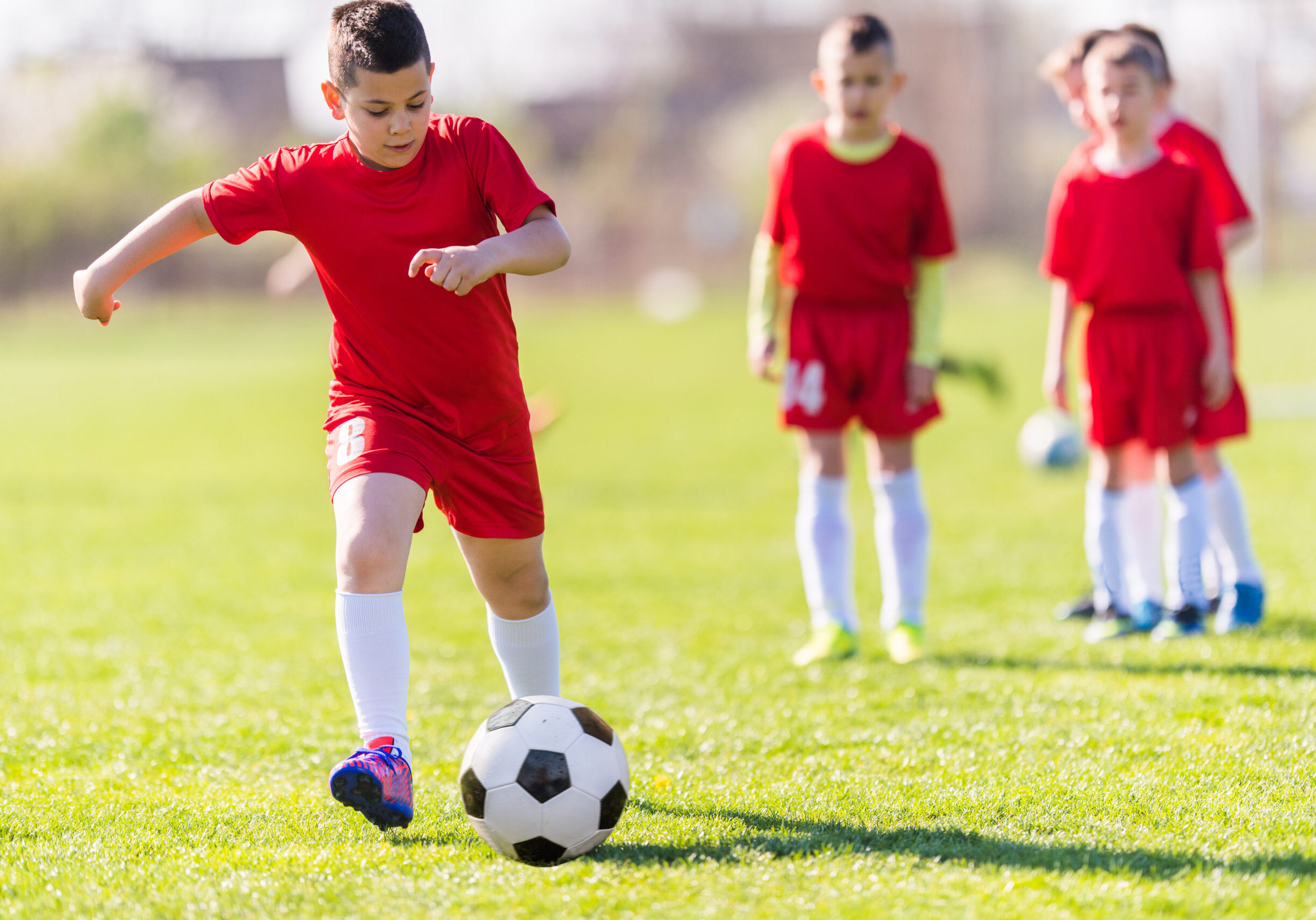 Kids soccer football - young children players match on soccer field