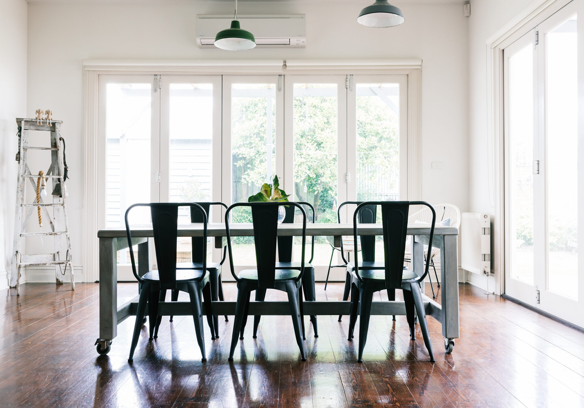 Gorgeous vintage styled light bright dining room with bifold doors