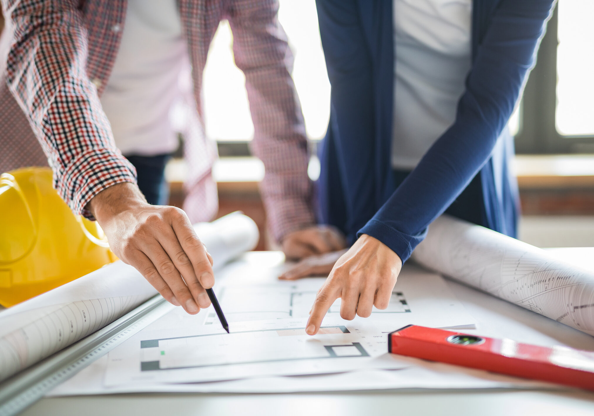 Architects working with blueprints in the office.